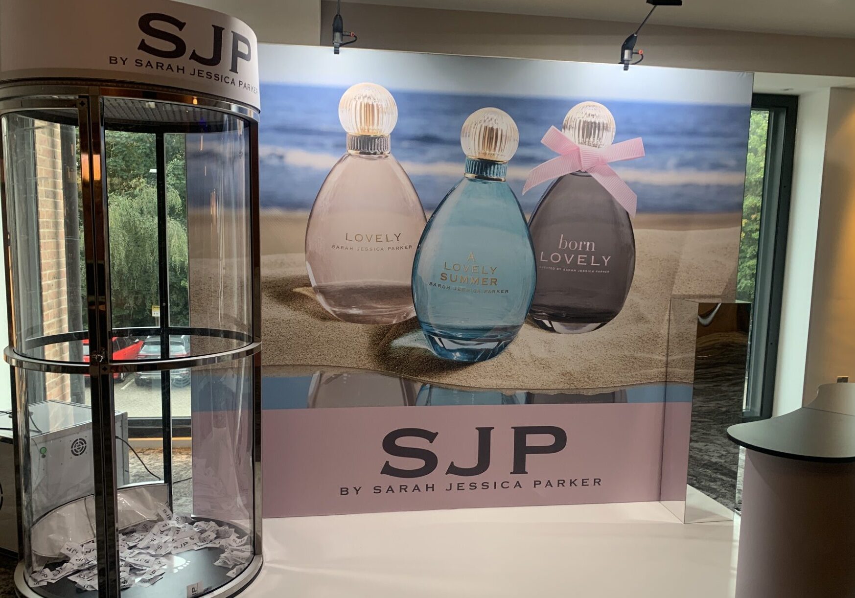 Display with three SJP perfumes and a branded booth for Sarah Jessica Parker’s fragrance line.